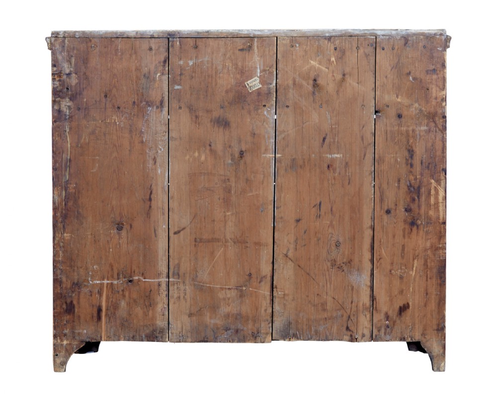 An early 19th-century Swedish pine chest of drawers featuring four graduated drawers with terracotta red paint and central metallic escutcheons. View V