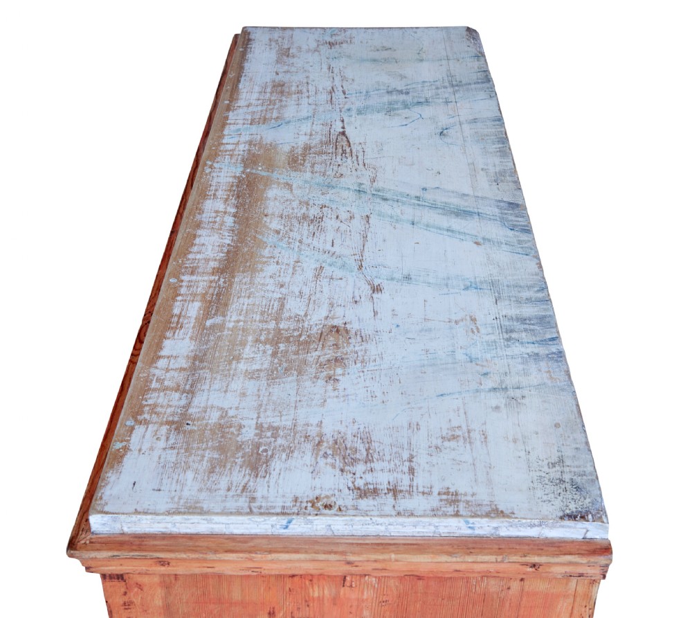 An early 19th-century Swedish pine chest of drawers featuring four graduated drawers with terracotta red paint and central metallic escutcheons. View VIII