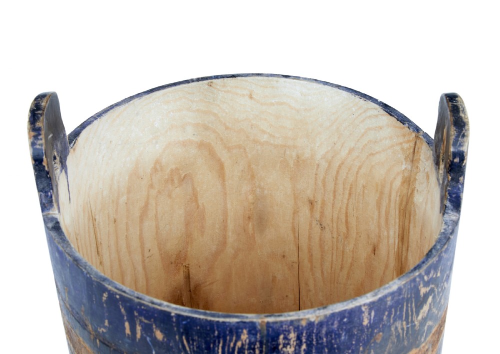 A mid-19th-century Swedish pine storage container featuring a distressed blue painted finish, stave construction, and an arched wooden top handle. View VI
