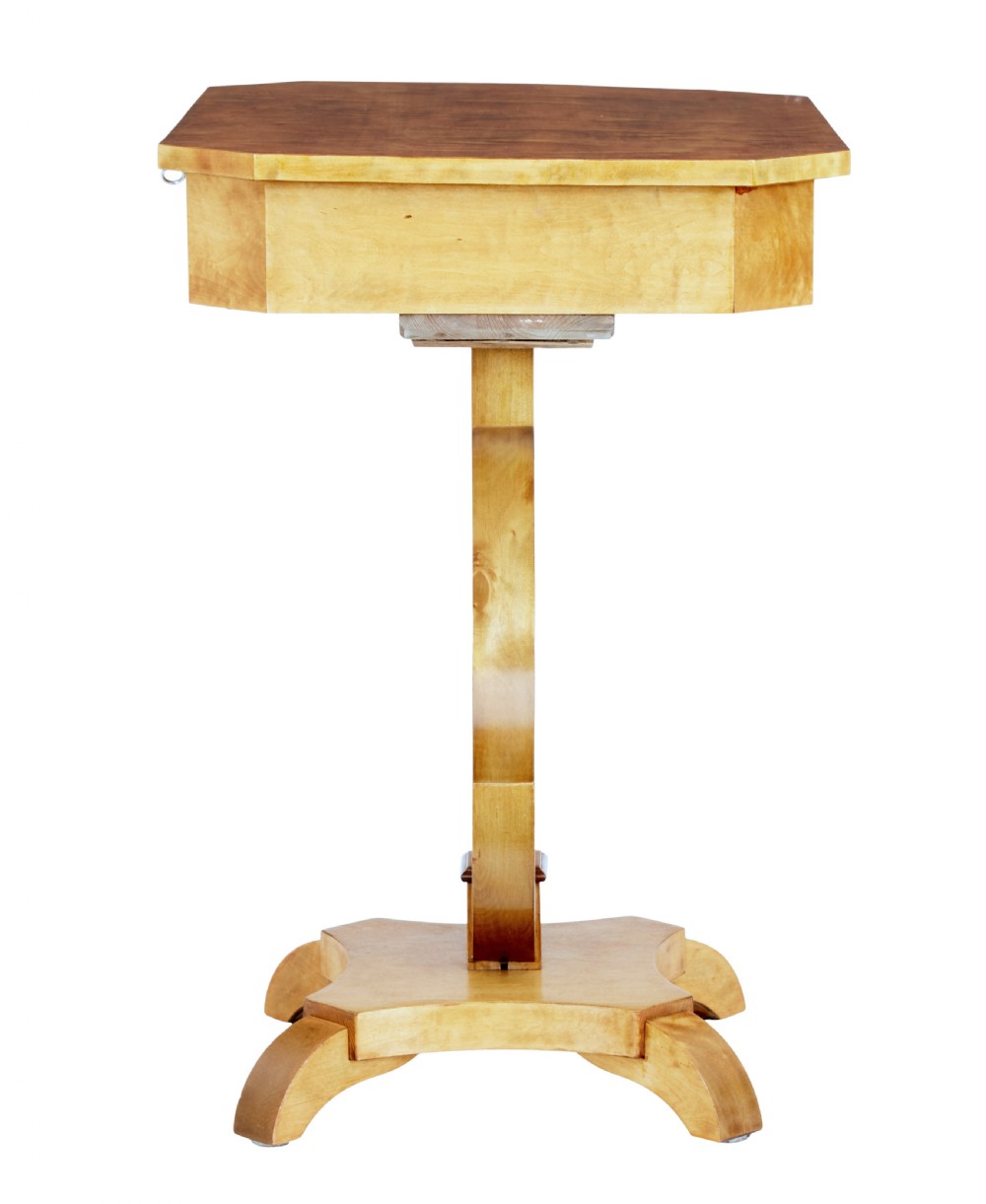 A 19th-century Swedish satin birch occasional table featuring a lyre-shaped pedestal base, a single drawer with a key, and a quadruped plinth. View IV
