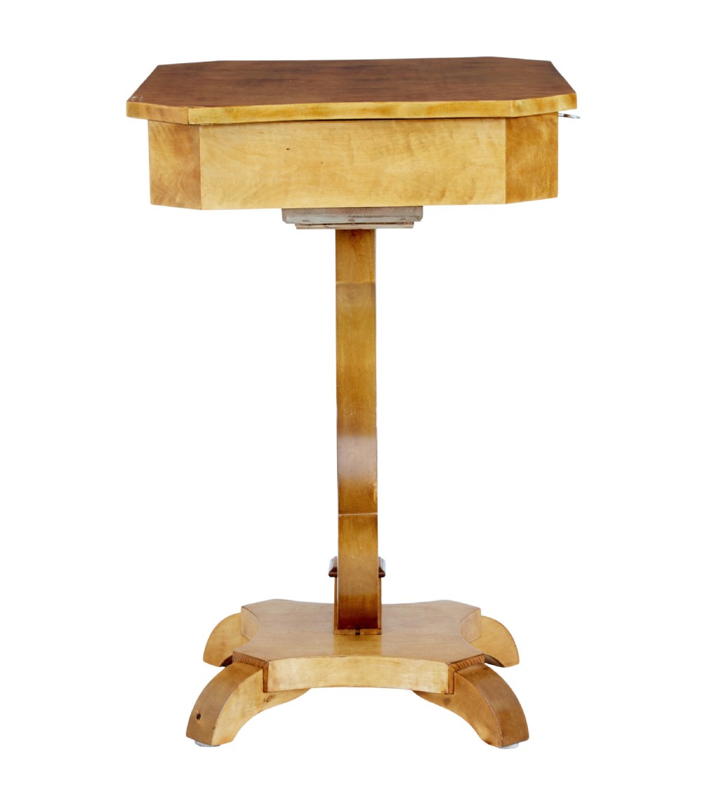 A 19th-century Swedish satin birch occasional table featuring a lyre-shaped pedestal base, a single drawer with a key, and a quadruped plinth. View V