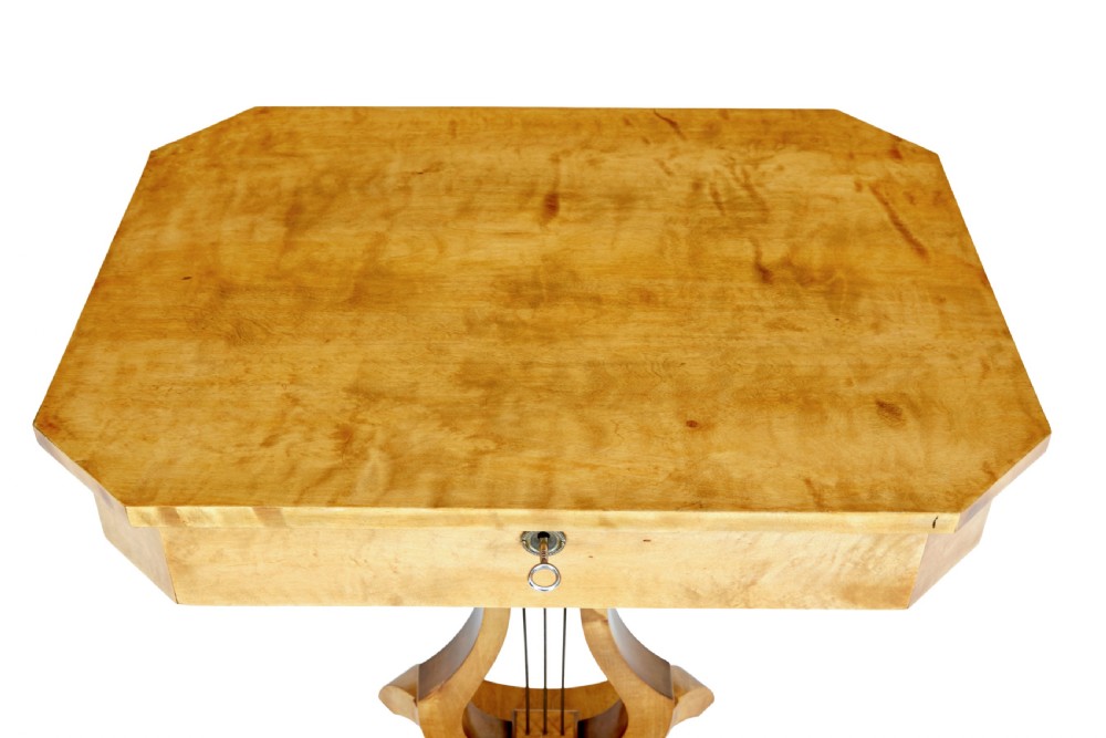 A 19th-century Swedish satin birch occasional table featuring a lyre-shaped pedestal base, a single drawer with a key, and a quadruped plinth. View VII