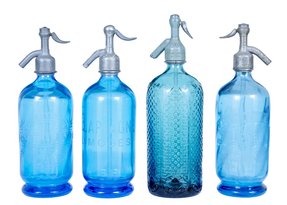 A set of four early twentieth-century French bright blue etched glass soda syphons with grey metal tops.