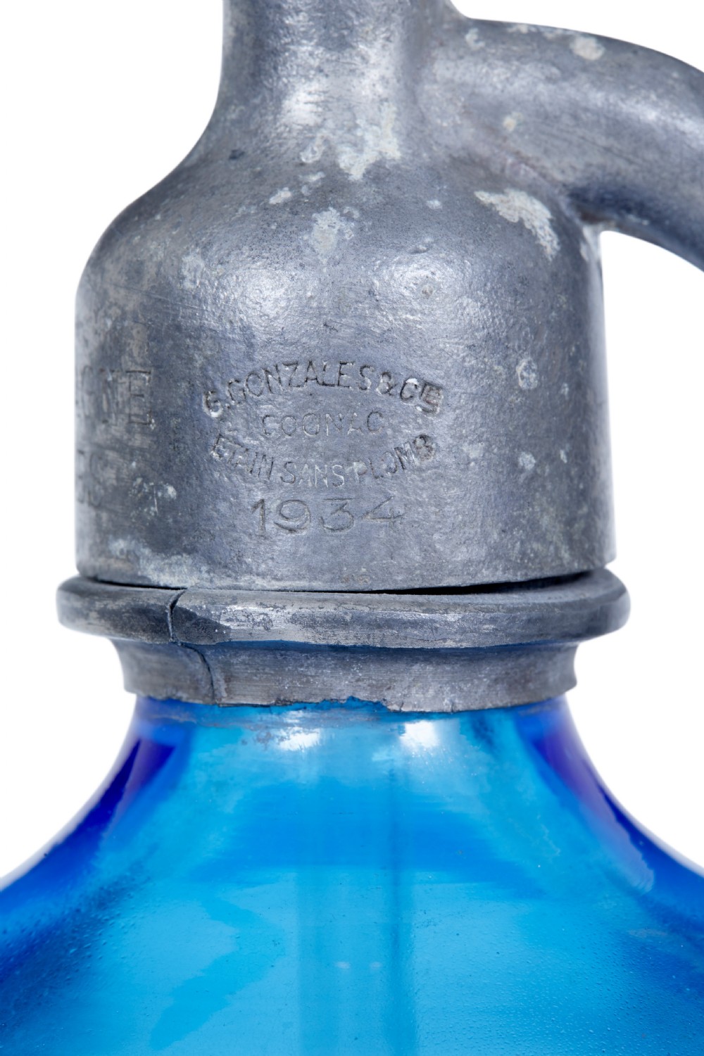 A set of four early twentieth-century French bright blue etched glass soda syphons with grey metal tops. View X