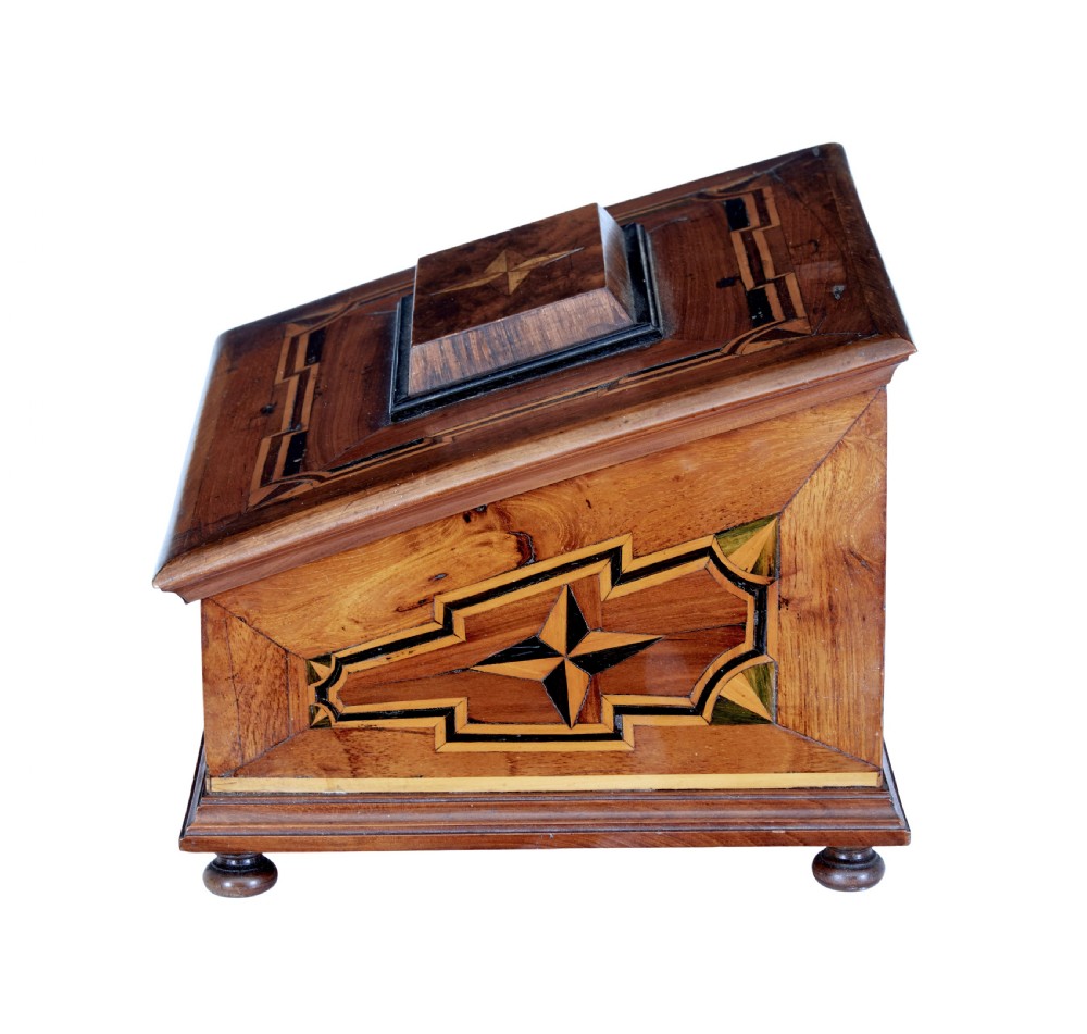 A 19th-century fruitwood desktop box featuring geometric marquetry star motifs, a raised stepped lid, keyhole, and small turned feet. View II