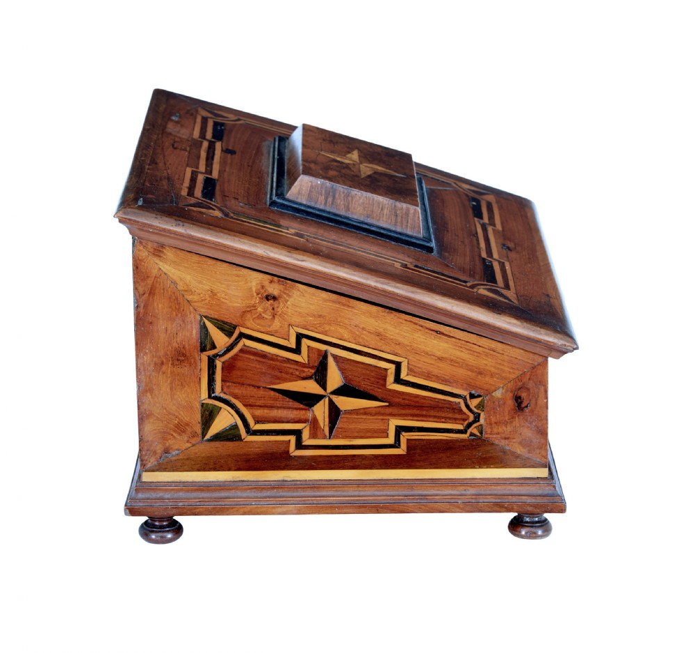 A 19th-century fruitwood desktop box featuring geometric marquetry star motifs, a raised stepped lid, keyhole, and small turned feet. View IV