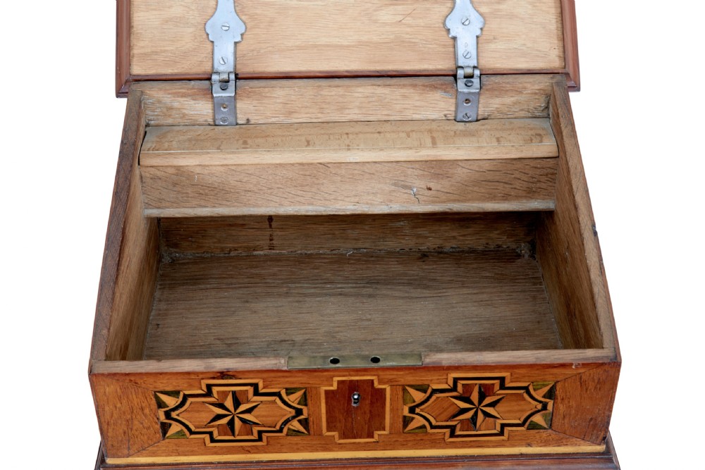 A 19th-century fruitwood desktop box featuring geometric marquetry star motifs, a raised stepped lid, keyhole, and small turned feet. View VI