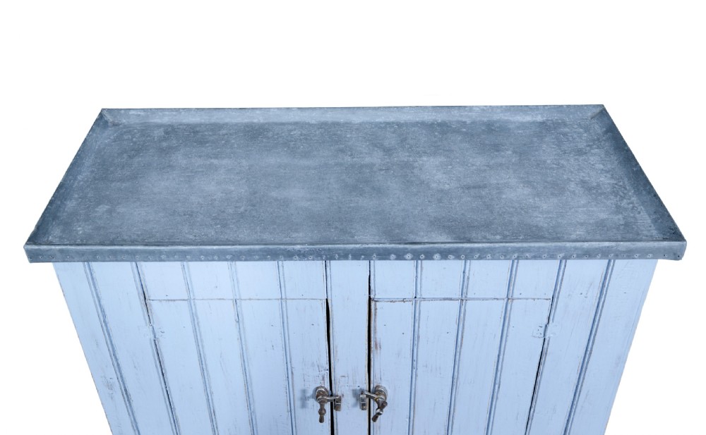 A 19th-century rustic light blue painted pine washstand featuring double planked doors with turn-latch handles and a metal-bound top. View III
