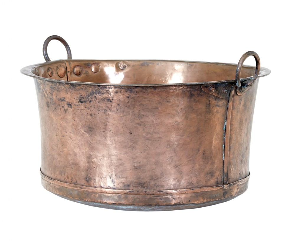 A large 19th-century hammered copper cooking vessel featuring a rounded base, riveted seams, and two wrought iron loop handles. View II