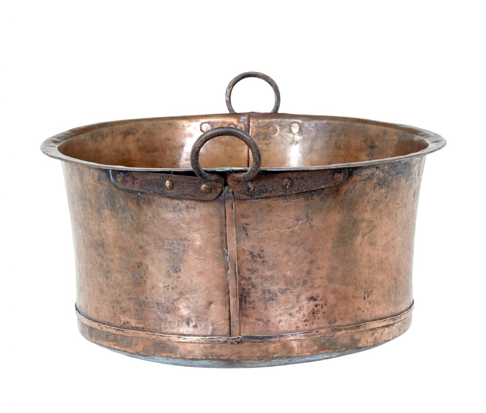 A large 19th-century hammered copper cooking vessel featuring a rounded base, riveted seams, and two wrought iron loop handles. View IV