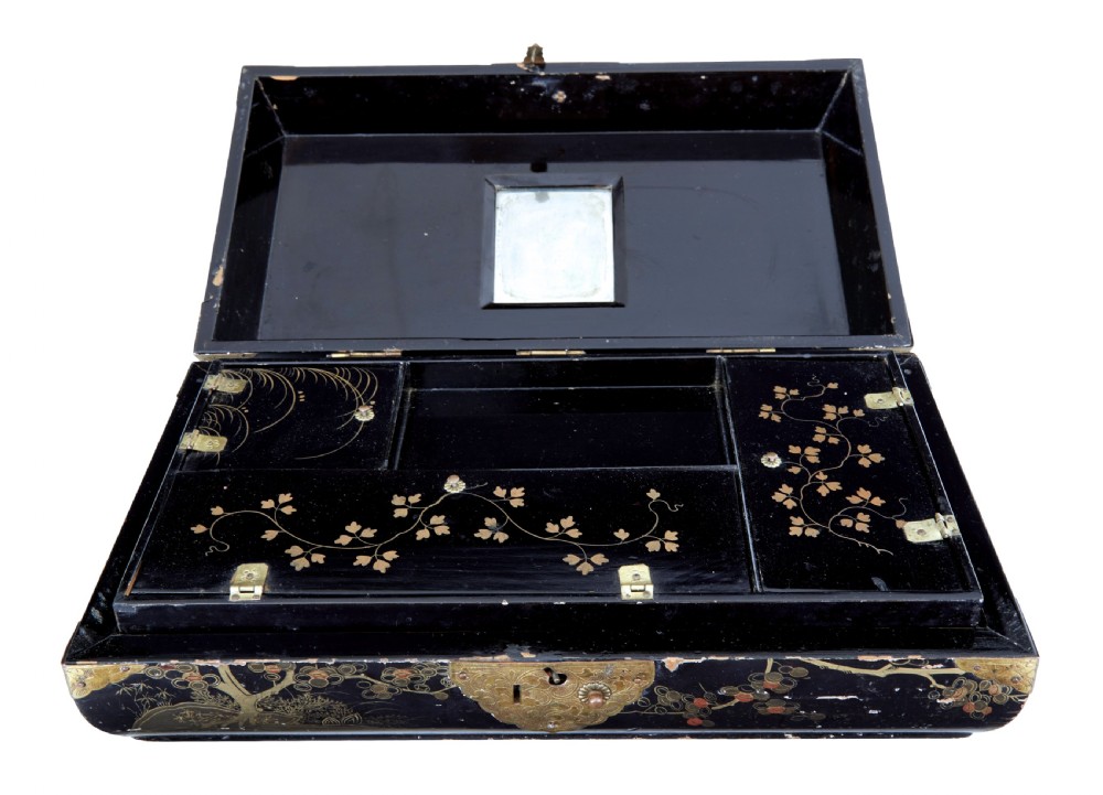 A 19th-century black lacquered jewellery box decorated with gilded botanical motifs, an ornate brass clasp, and a pale blue padded silk top. View II