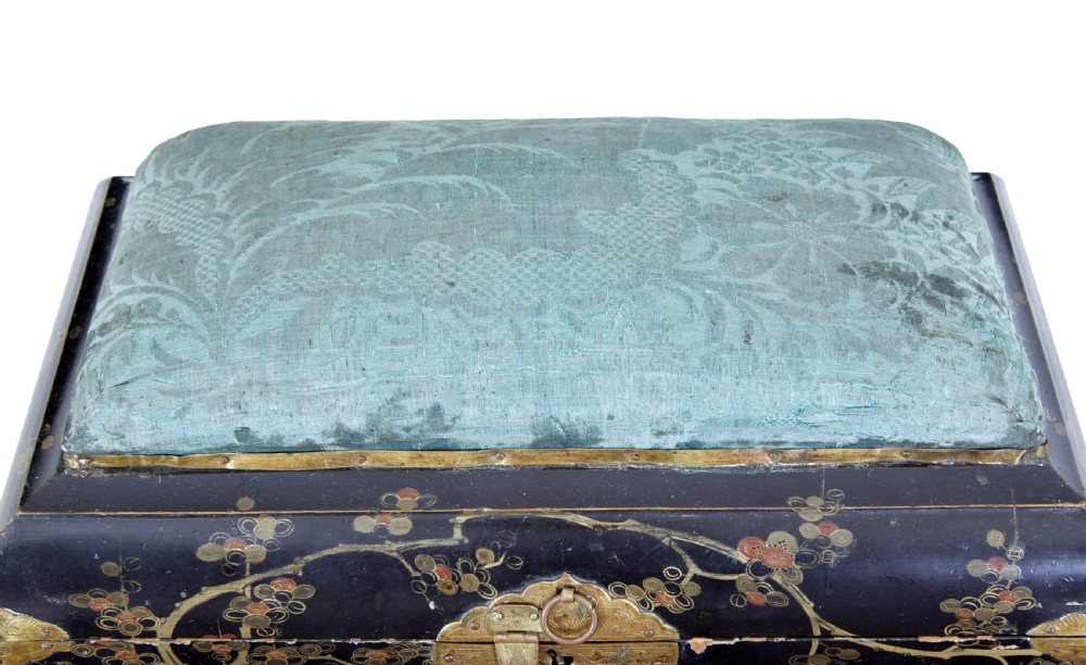 A 19th-century black lacquered jewellery box decorated with gilded botanical motifs, an ornate brass clasp, and a pale blue padded silk top. View VI