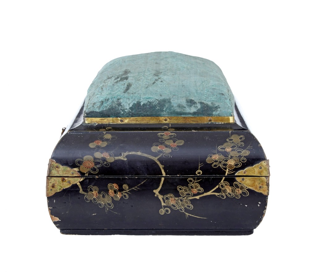 A 19th-century black lacquered jewellery box decorated with gilded botanical motifs, an ornate brass clasp, and a pale blue padded silk top. View IX