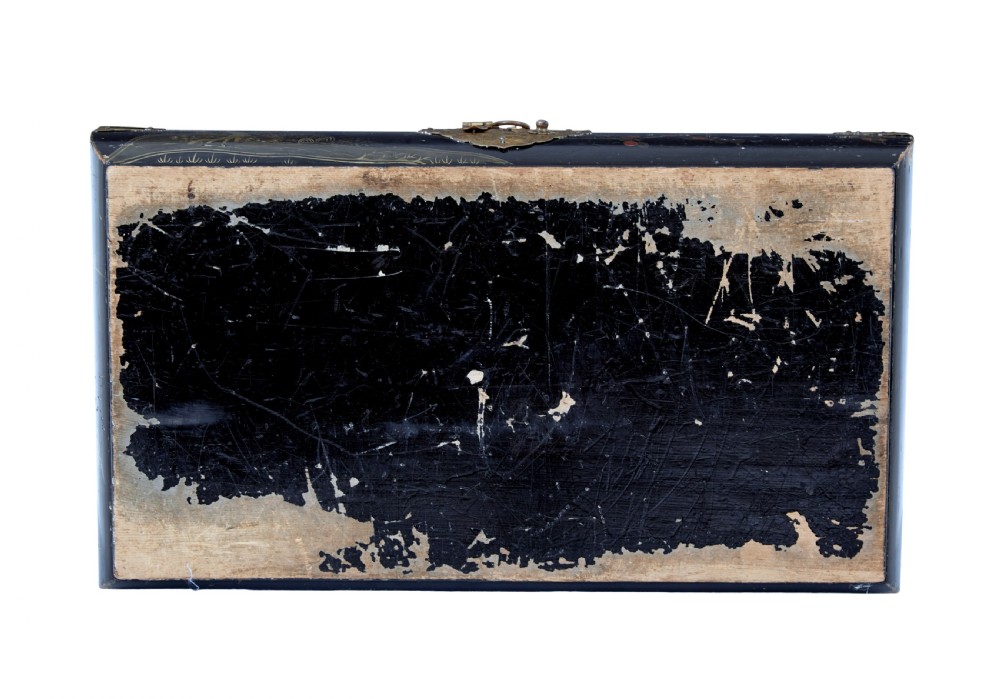 A 19th-century black lacquered jewellery box decorated with gilded botanical motifs, an ornate brass clasp, and a pale blue padded silk top. View XII