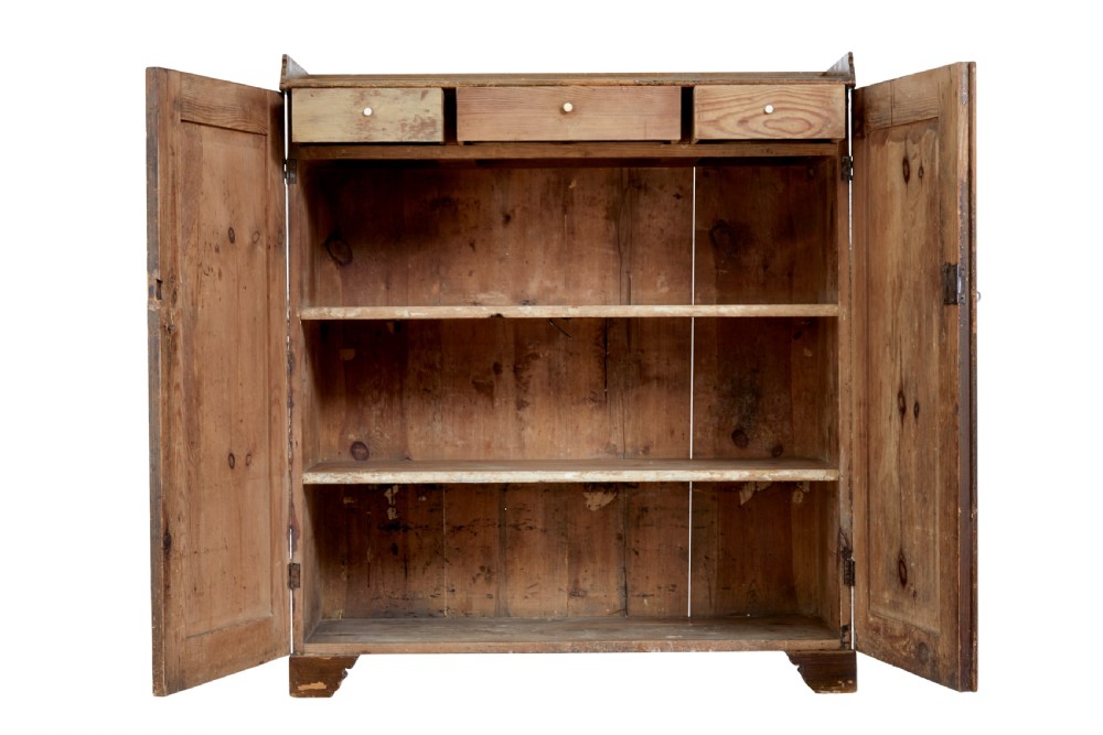A 19th-century Swedish pine cupboard featuring two panelled doors with faux-wood grain paintwork and a low shaped splashback. View III