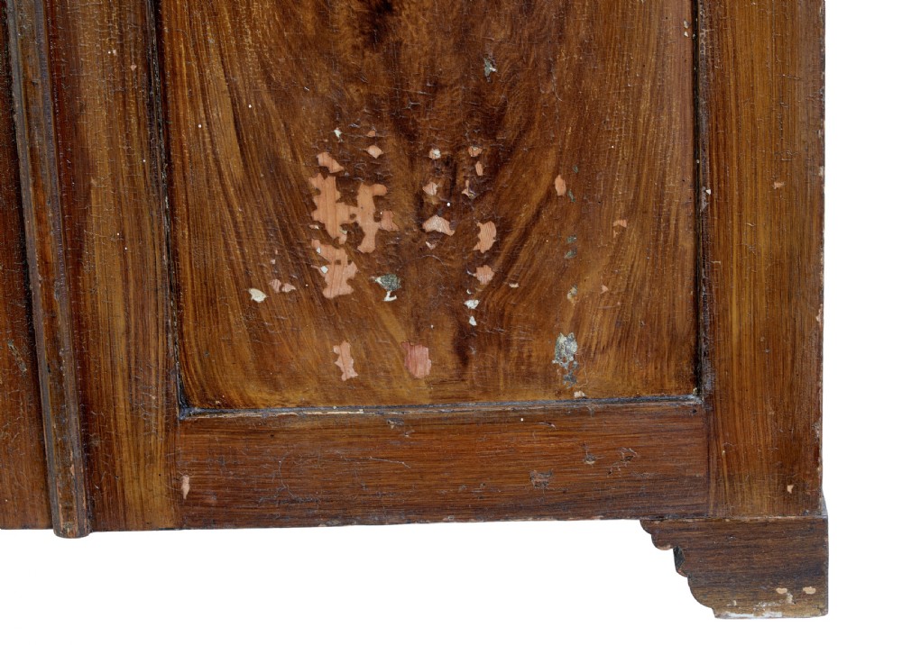 A 19th-century Swedish pine cupboard featuring two panelled doors with faux-wood grain paintwork and a low shaped splashback. View V