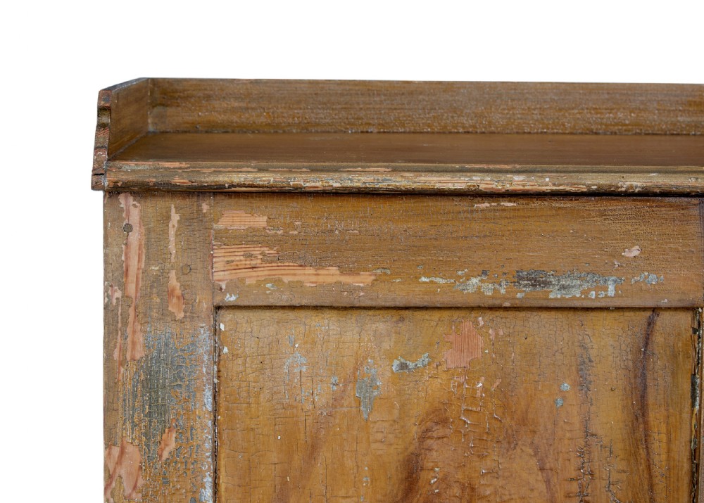 A 19th-century Swedish pine cupboard featuring two panelled doors with faux-wood grain paintwork and a low shaped splashback. View VIII