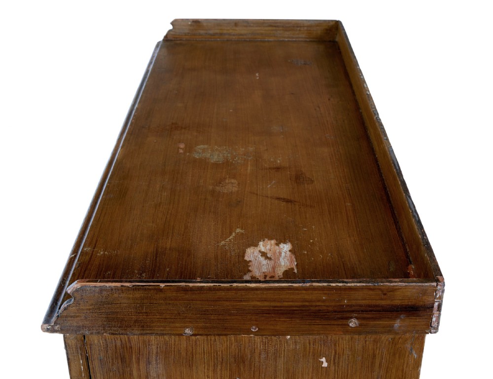 A 19th-century Swedish pine cupboard featuring two panelled doors with faux-wood grain paintwork and a low shaped splashback. View X