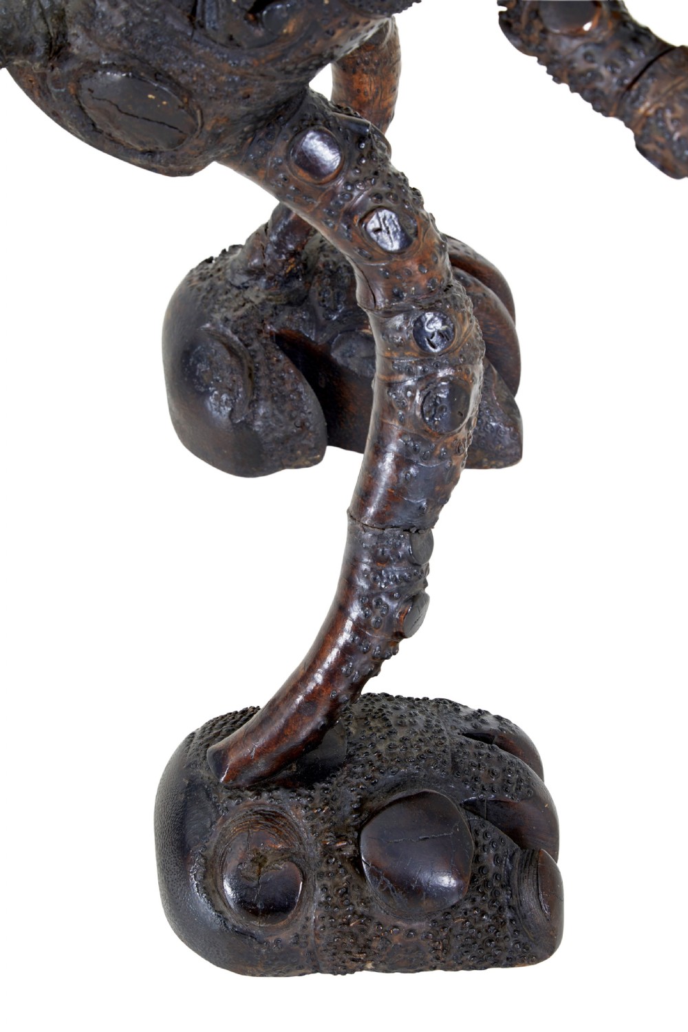 A dark brown hand-carved mango wood novelty figure with inset yellow glass eyes and long textured limbs. View XI
