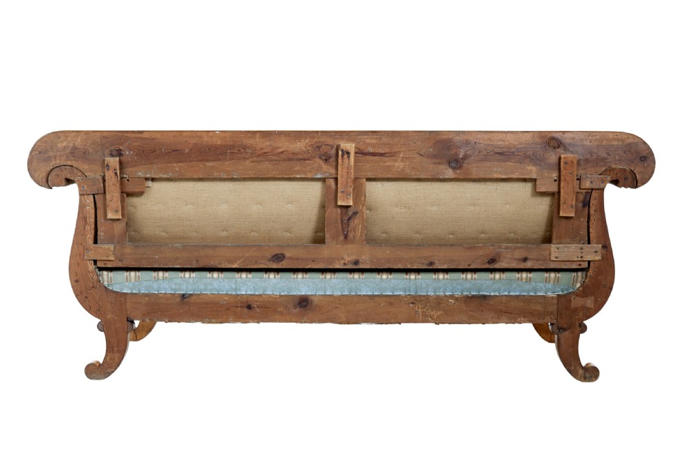 A 19th-century Swedish carved birch sofa featuring scrolled arms, floral rosettes, swept feet, and light blue and white striped upholstery. View IV