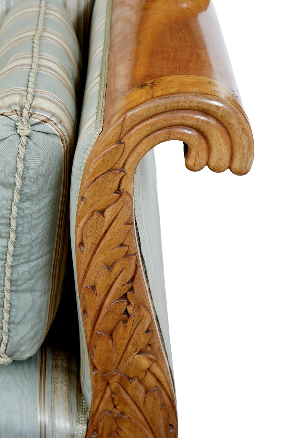 A 19th-century Swedish carved birch sofa featuring scrolled arms, floral rosettes, swept feet, and light blue and white striped upholstery. View IX