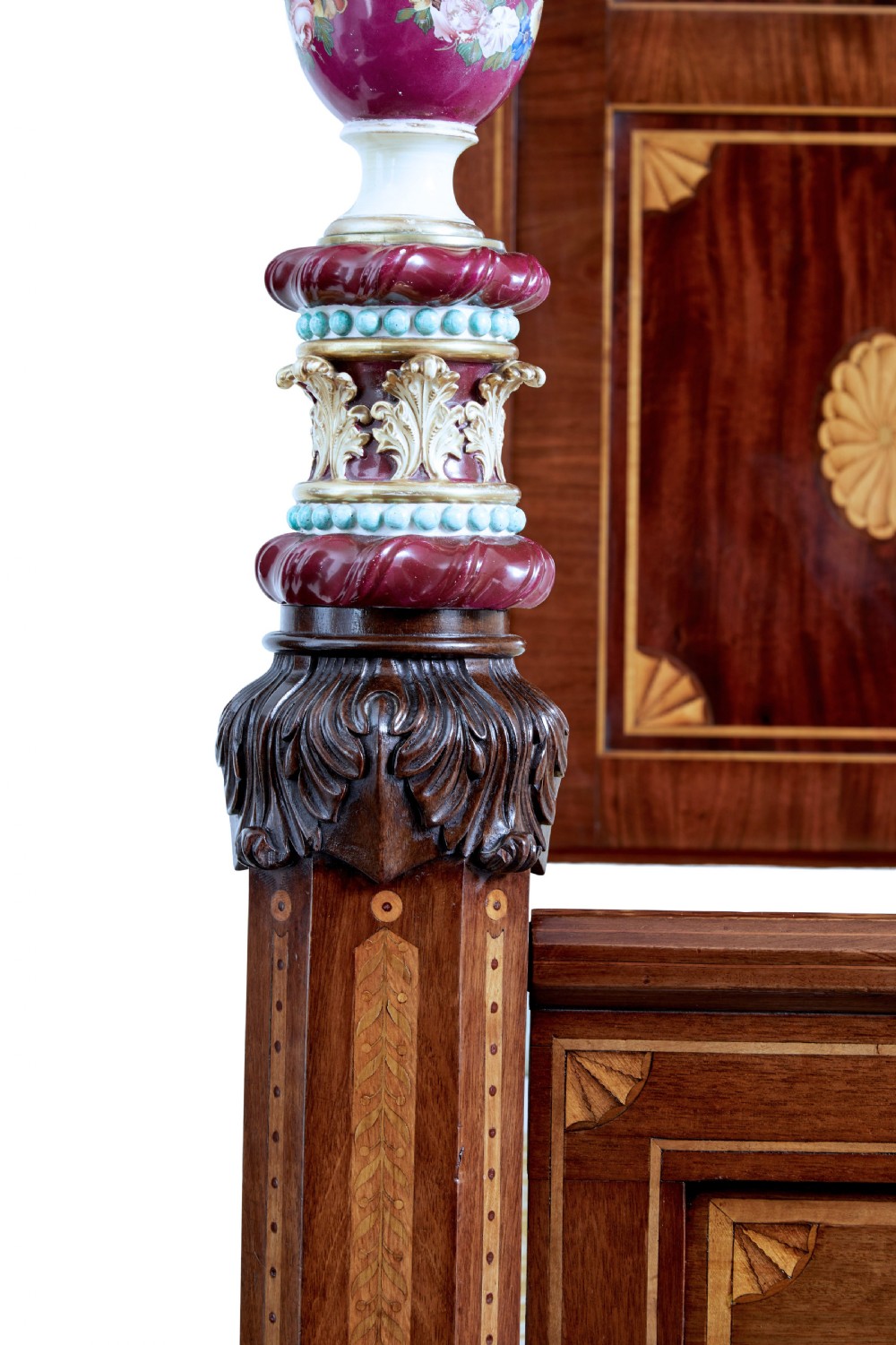 A nineteenth-century mahogany four-poster bed frame featuring carved posts with pink porcelain sections, marquetry panelling, and an ornate trefoil canopy trim. View VIII