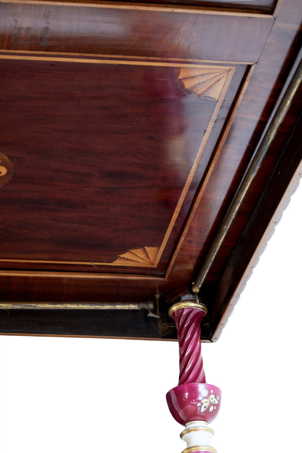 A nineteenth-century mahogany four-poster bed frame featuring carved posts with pink porcelain sections, marquetry panelling, and an ornate trefoil canopy trim. View XXV