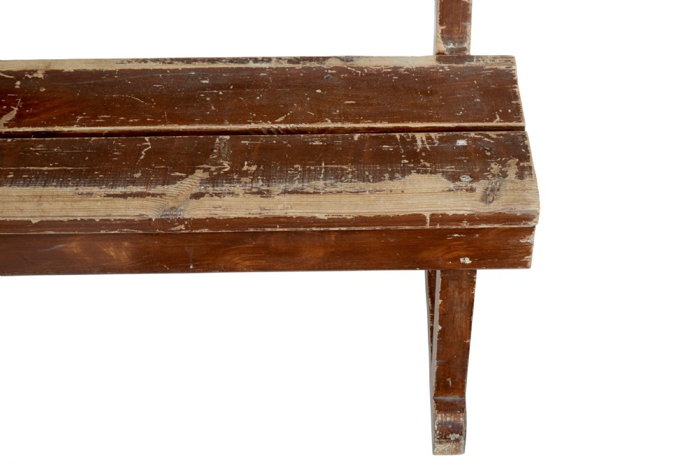 A pair of long, rustic pine benches with slatted backrests, trestle-style legs, and a distressed reddish-brown painted finish. View VIII