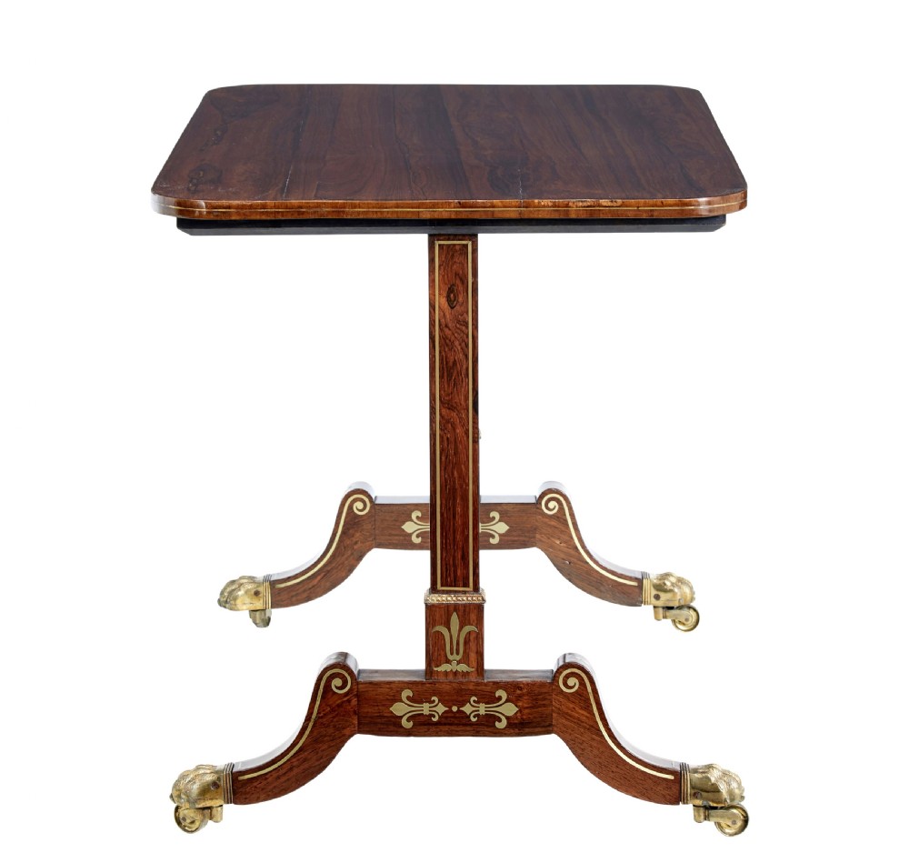 An early 19th-century Regency dark wood side table with delicate brass inlay, trestle base, and brass claw feet on castors. View IV