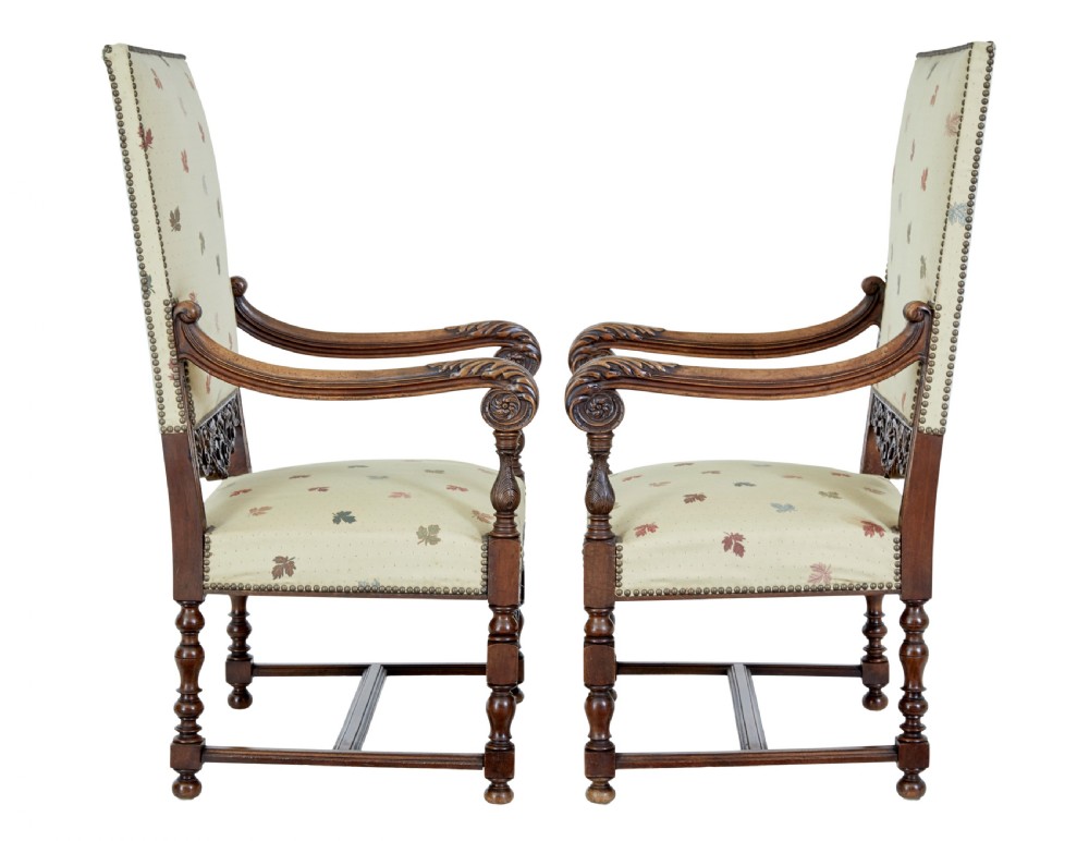 Pair of 19th-century French carved walnut armchairs with high rectangular backs, scroll arms, and cream leaf-patterned upholstery. View VII
