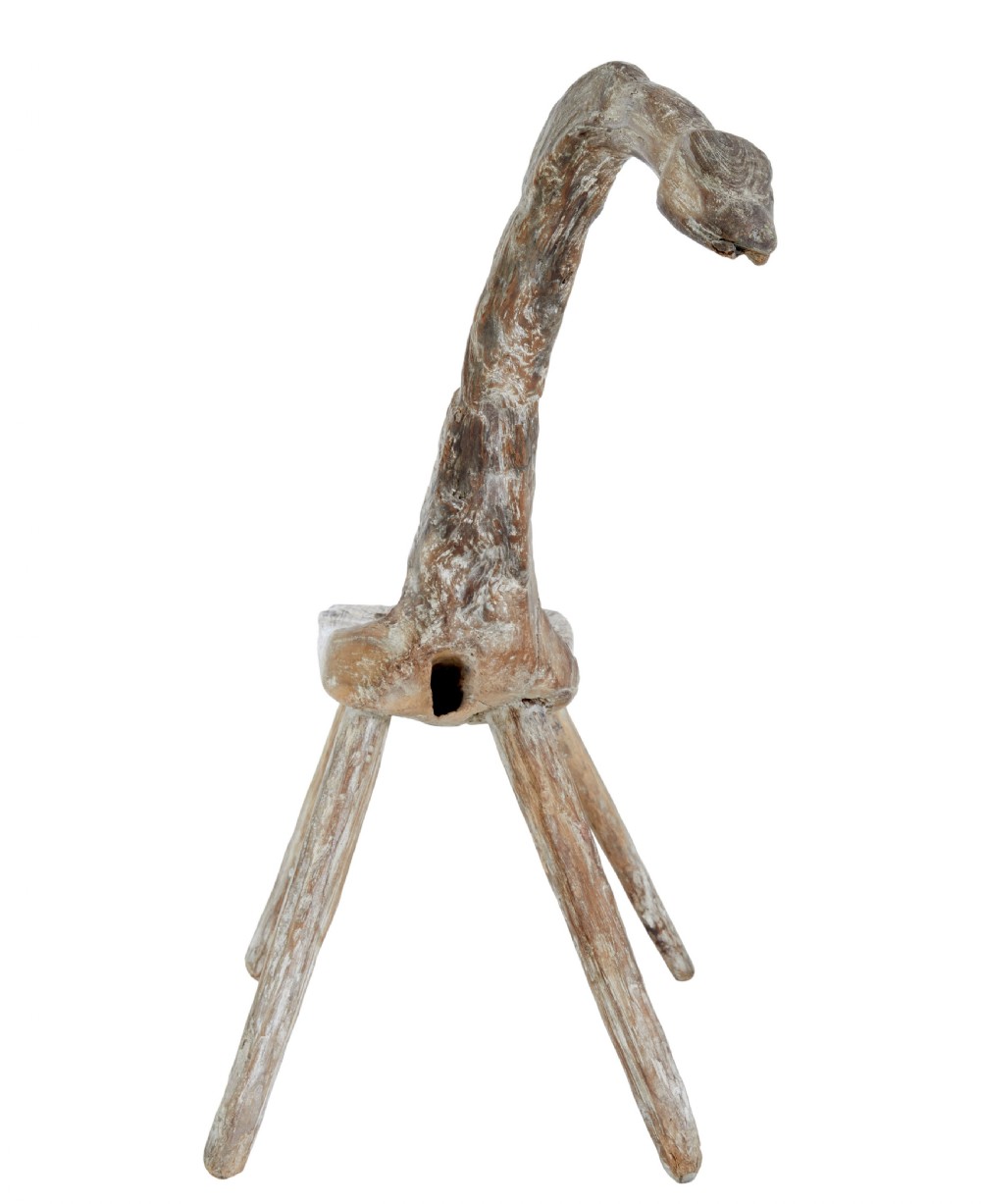A rustic 19th-century childs stool crafted from weathered natural form oak timber, featuring a curved zoomorphic backrest and four splayed legs. View II