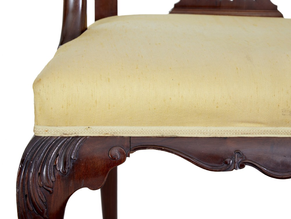A pair of 19th-century Chippendale style mahogany armchairs featuring pierced back splats, curved armrests, yellow upholstered drop-in seats, and carved cabriole legs. View II