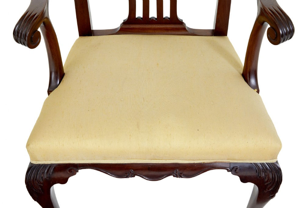 A pair of 19th-century Chippendale style mahogany armchairs featuring pierced back splats, curved armrests, yellow upholstered drop-in seats, and carved cabriole legs. View IV