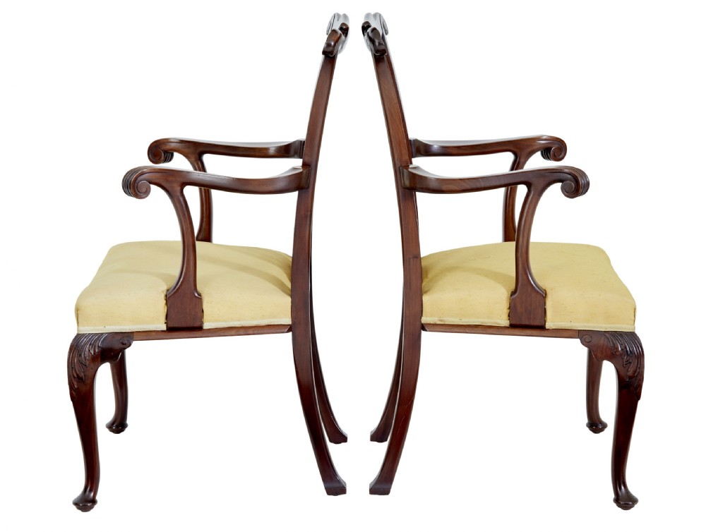 A pair of 19th-century Chippendale style mahogany armchairs featuring pierced back splats, curved armrests, yellow upholstered drop-in seats, and carved cabriole legs. View VII
