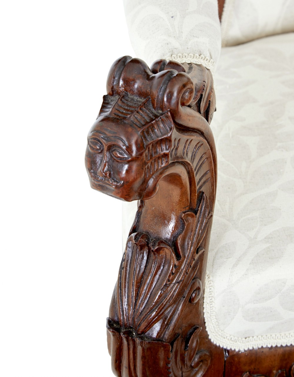 A mid-19th-century carved walnut armchair featuring figurative arm supports and cream patterned upholstery. View VIII