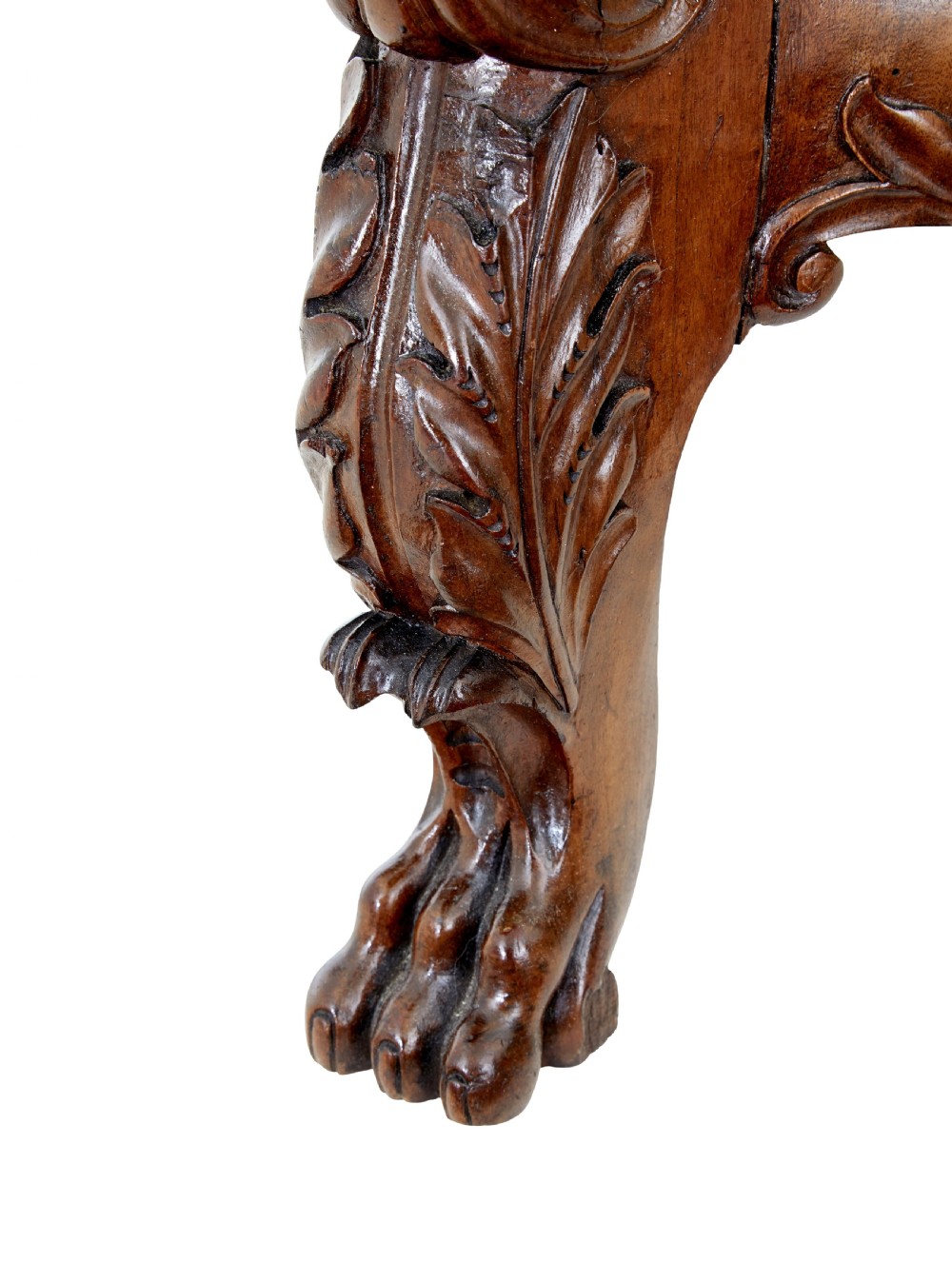 A mid-19th-century carved walnut armchair featuring figurative arm supports and cream patterned upholstery. View IX