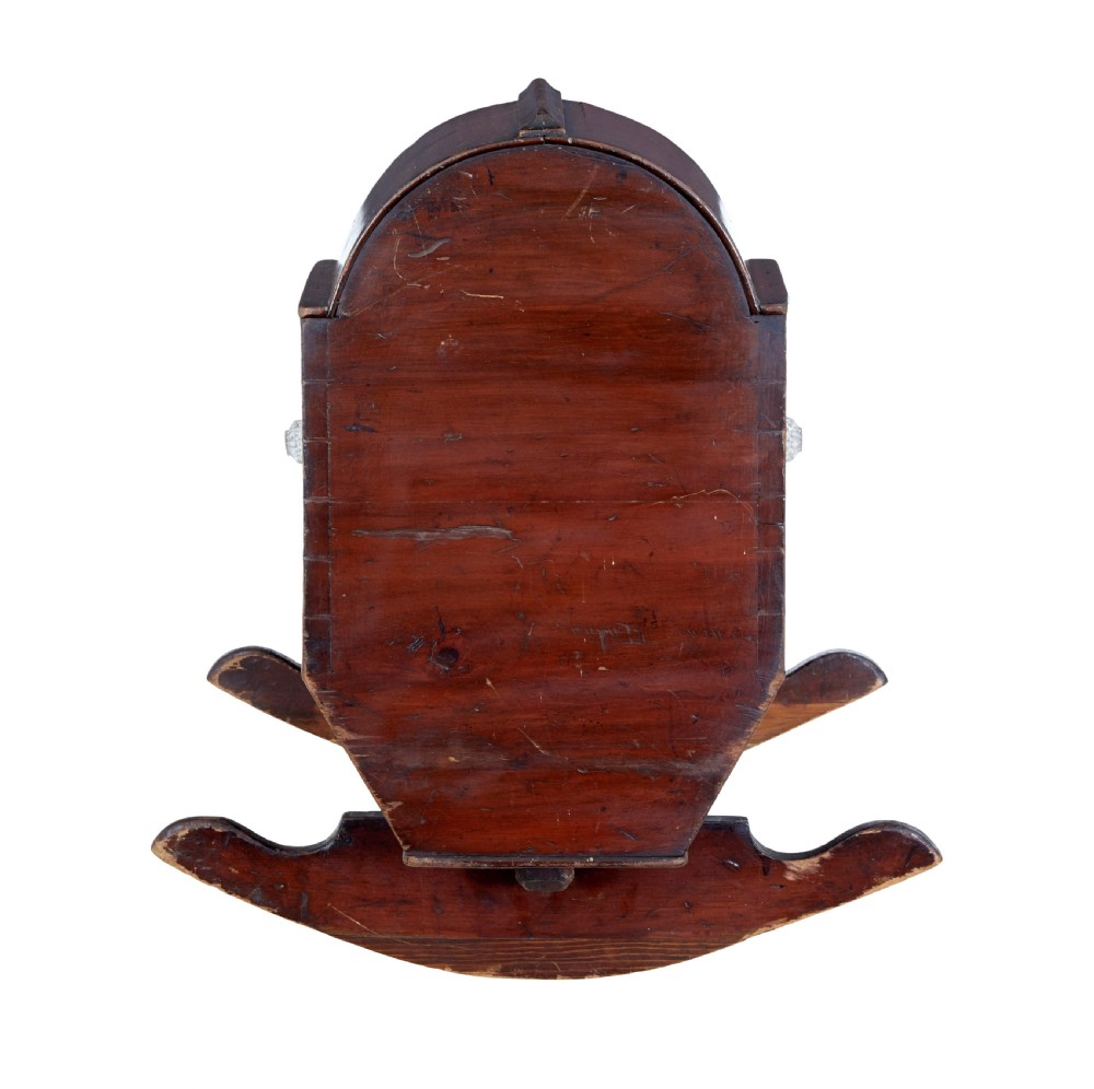 A Victorian pine rocking cradle featuring a curved canopy hood, a dark reddish-brown finish, and two solid wood rockers at the base. View III