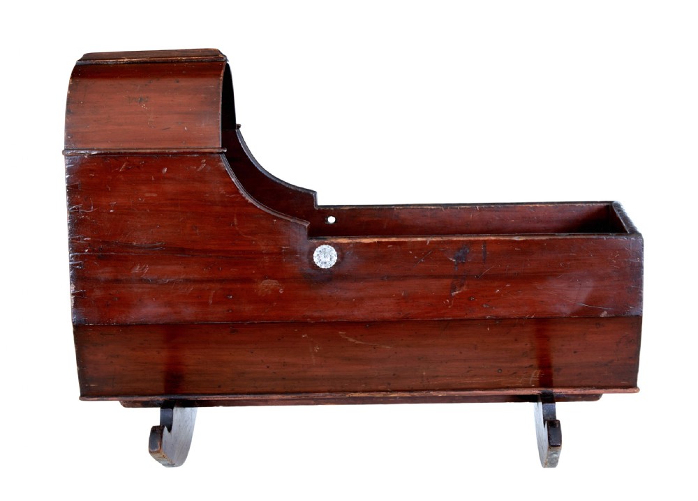 A Victorian pine rocking cradle featuring a curved canopy hood, a dark reddish-brown finish, and two solid wood rockers at the base. View VI