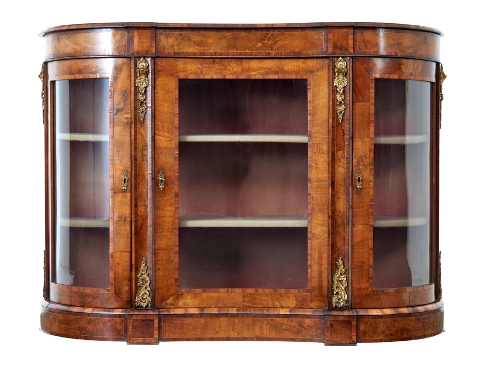A 19th-century Victorian burr walnut glazed credenza featuring curved glass side doors and decorative gilt metal mounts.