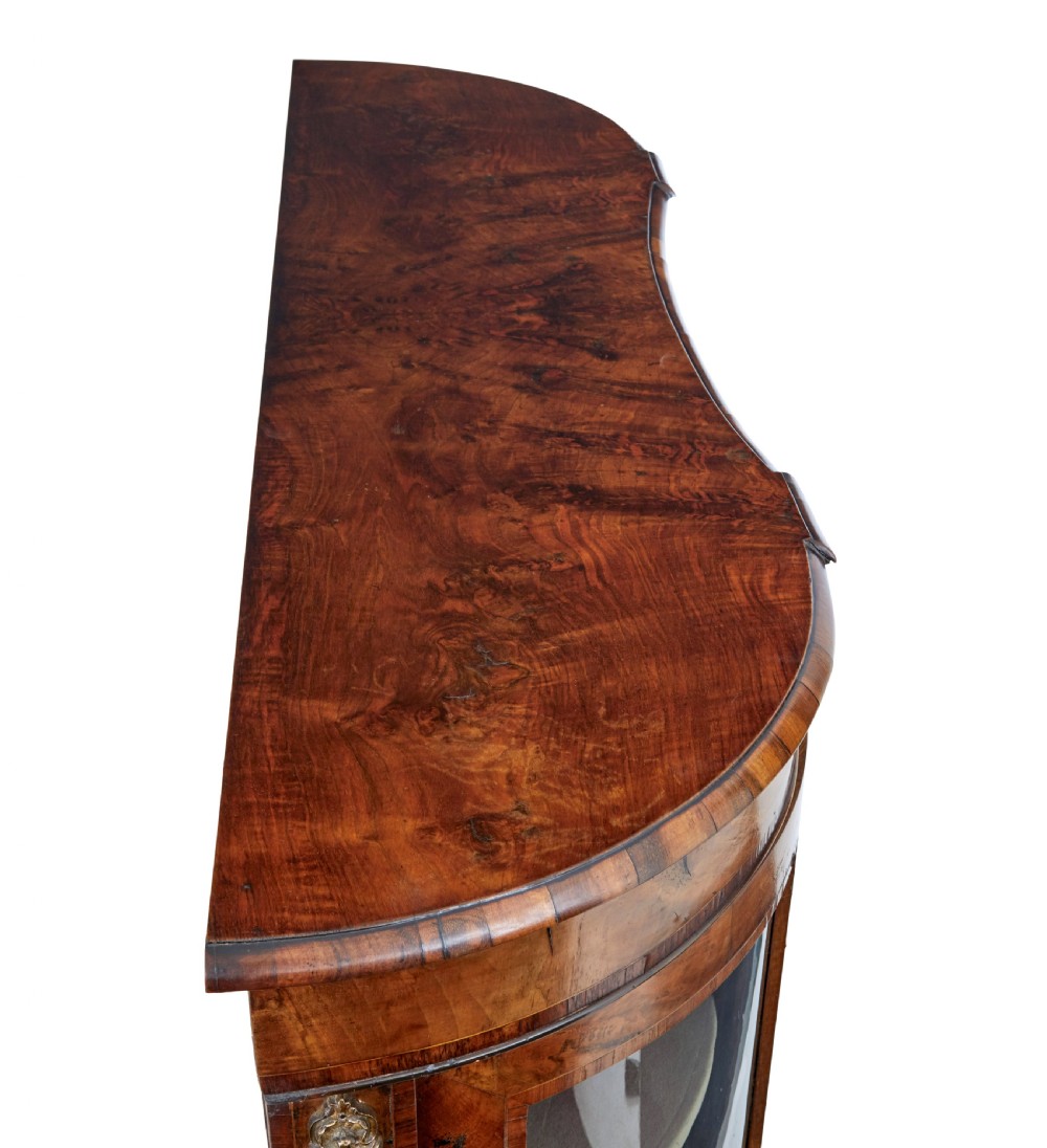 A 19th-century Victorian burr walnut glazed credenza featuring curved glass side doors and decorative gilt metal mounts. View IX
