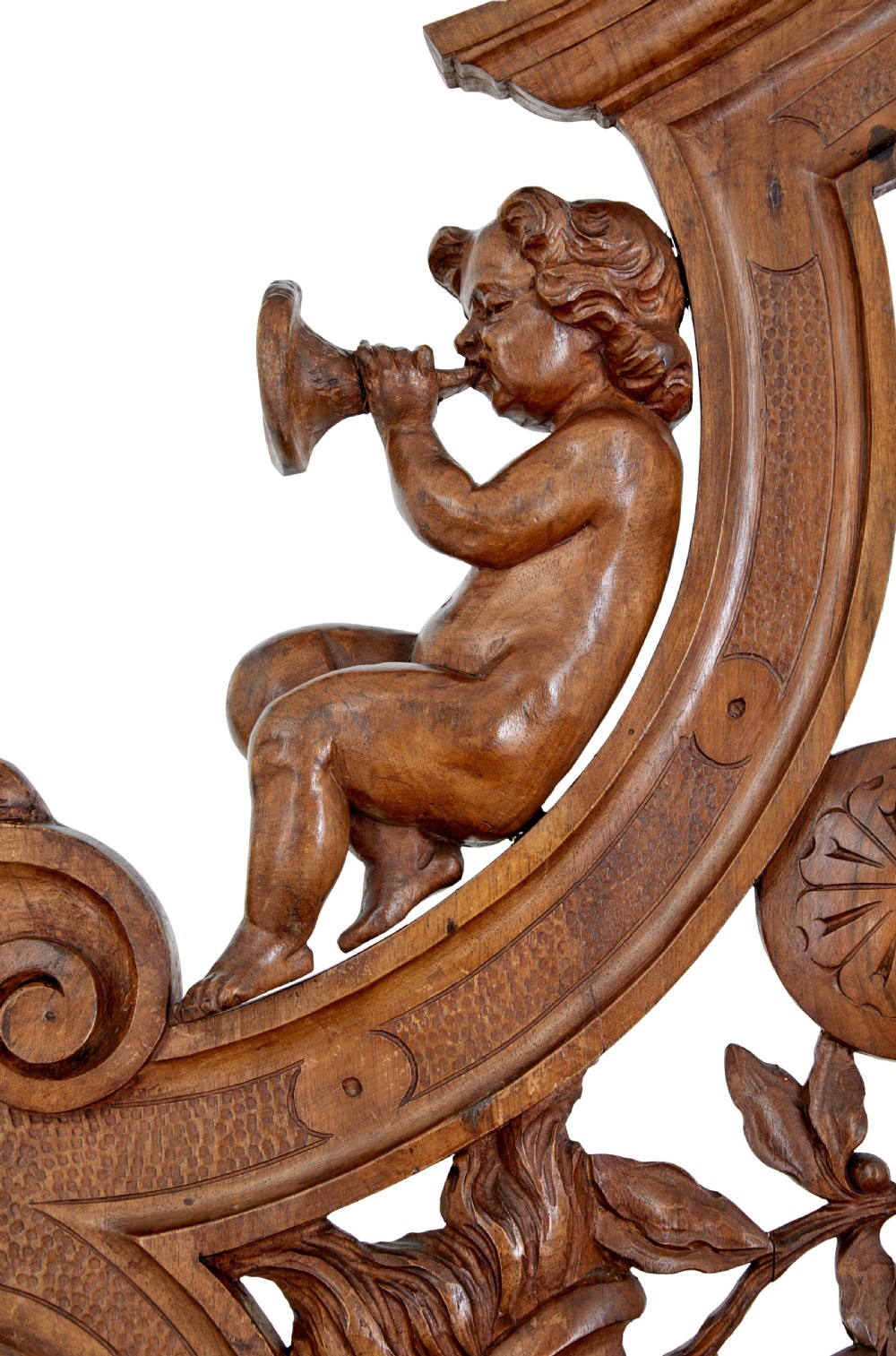 A 19th-century Flemish walnut hall chair decorated with openwork carvings of grotesque masks, cherubs blowing trumpets, and a central shield motif. View VIII