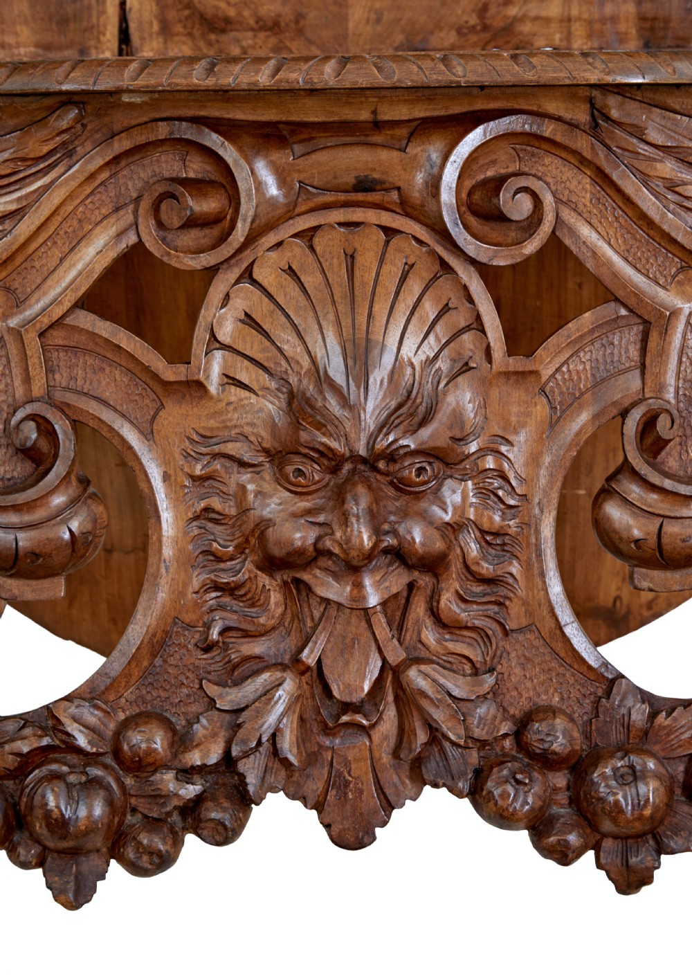 A 19th-century Flemish walnut hall chair decorated with openwork carvings of grotesque masks, cherubs blowing trumpets, and a central shield motif. View XII