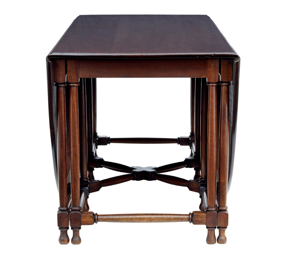 An early 20th-century mahogany gateleg dining table shown with both drop-down leaves folded against turned wooden legs. View IV