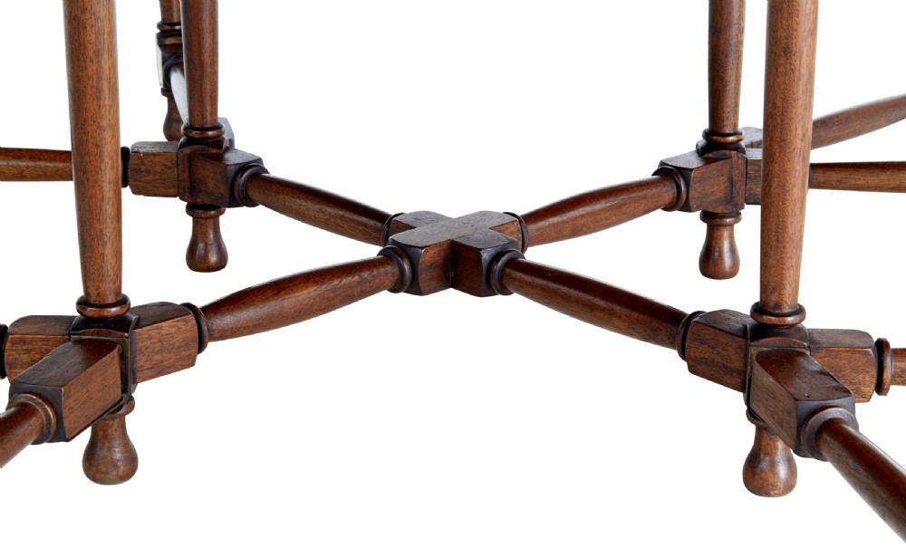 An early 20th-century mahogany gateleg dining table shown with both drop-down leaves folded against turned wooden legs. View VIII