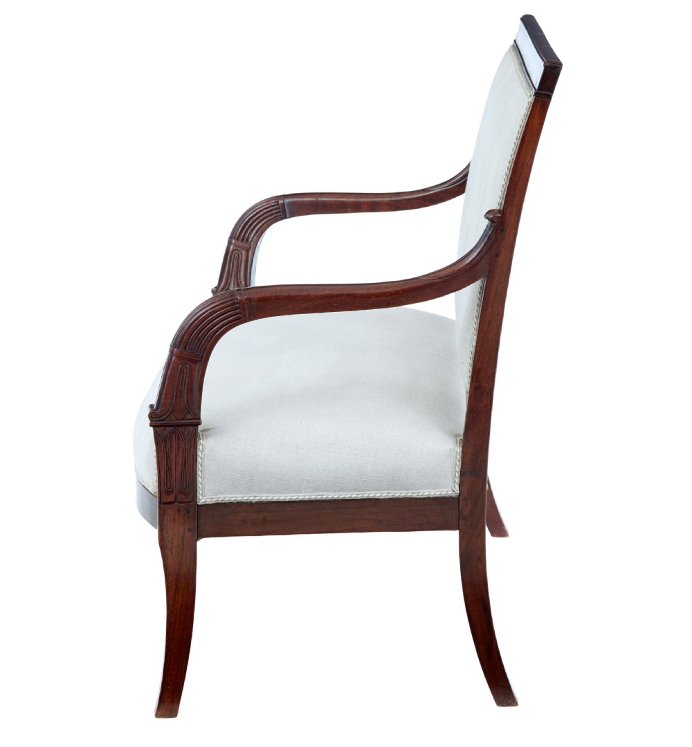 A seven-piece nineteenth-century French Empire mahogany salon suite upholstered in off-white fabric with carved reeded armrests. View III