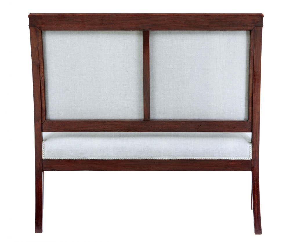 A seven-piece nineteenth-century French Empire mahogany salon suite upholstered in off-white fabric with carved reeded armrests. View IV