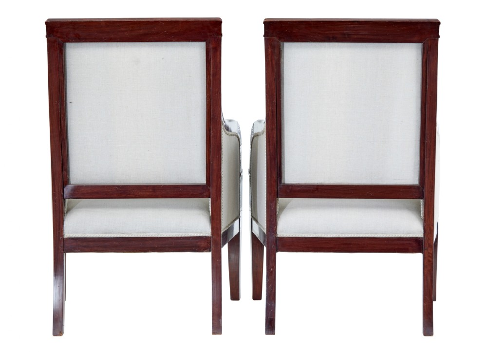 A seven-piece nineteenth-century French Empire mahogany salon suite upholstered in off-white fabric with carved reeded armrests. View VII