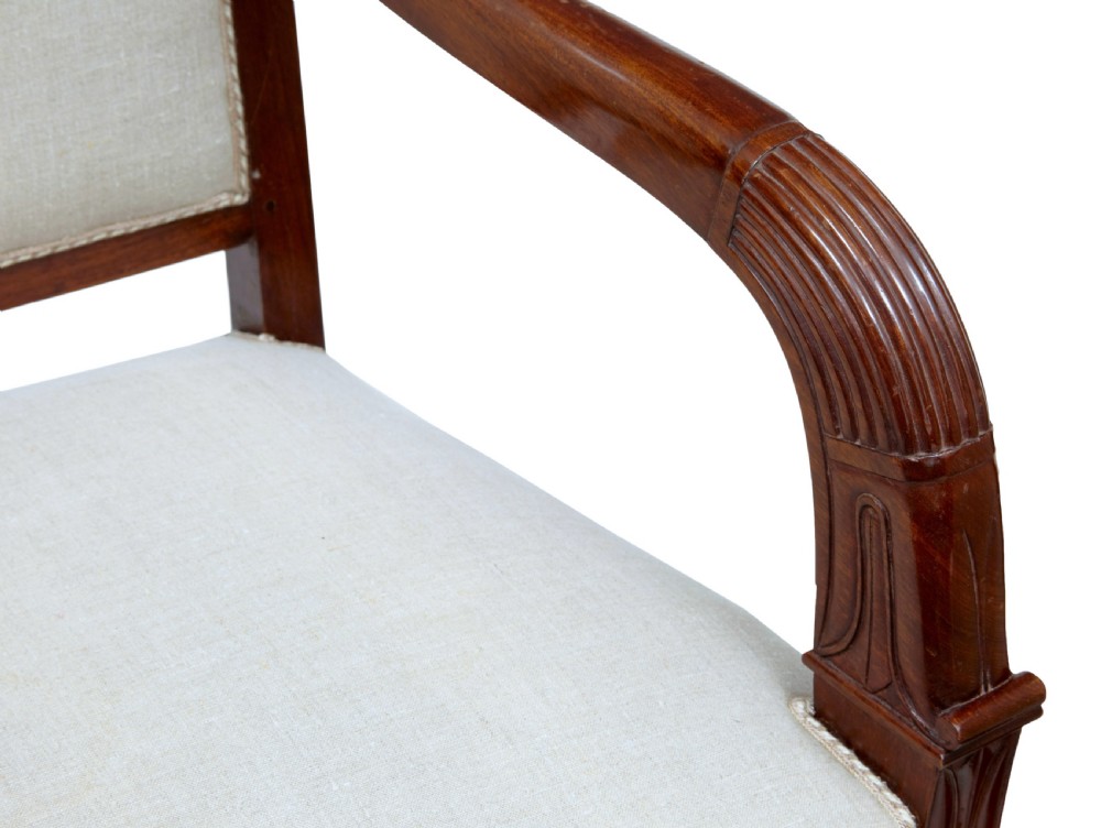 A seven-piece nineteenth-century French Empire mahogany salon suite upholstered in off-white fabric with carved reeded armrests. View XI