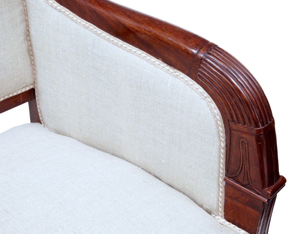 A seven-piece nineteenth-century French Empire mahogany salon suite upholstered in off-white fabric with carved reeded armrests. View XII