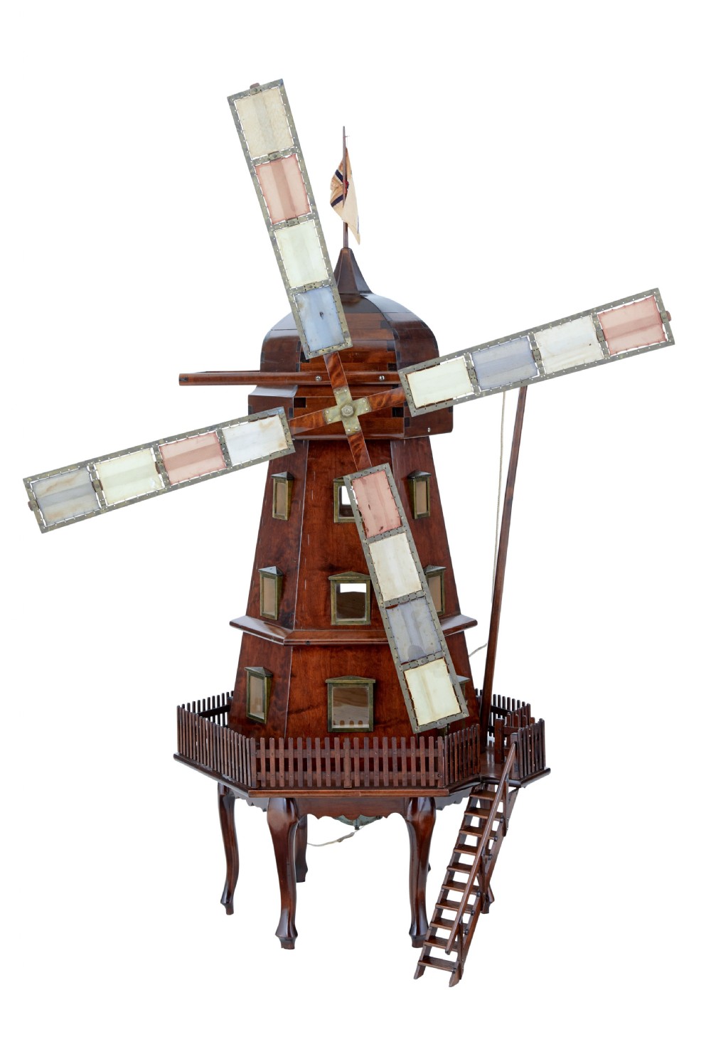 An early twentieth-century wooden scale model of a Dutch windmill, featuring multi-pane sails, brass fittings, a railed balcony, and a wooden ladder.